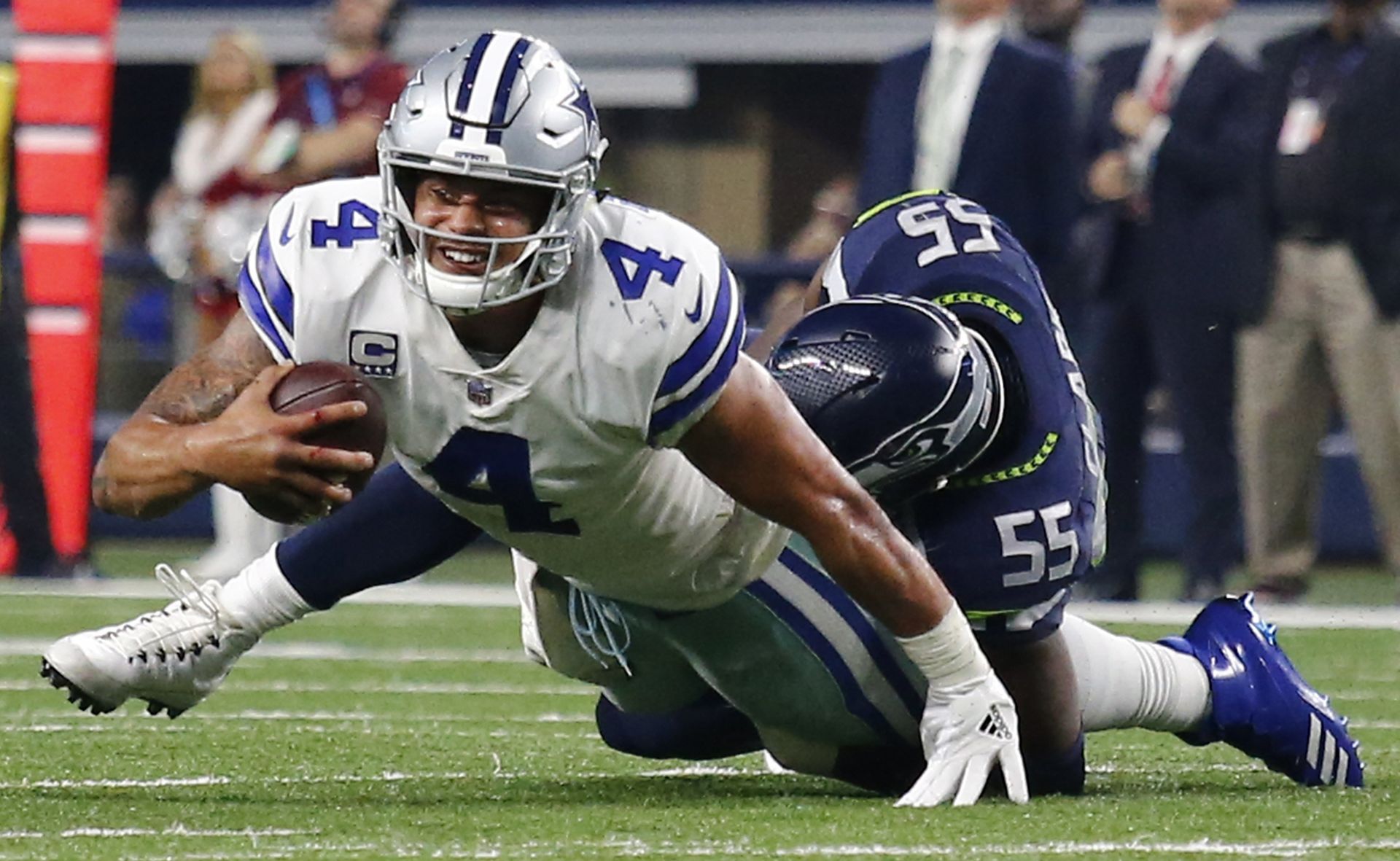 Dallas Cowboys quarterback Dak Prescott (L) is sacked by Seattle Seahawk